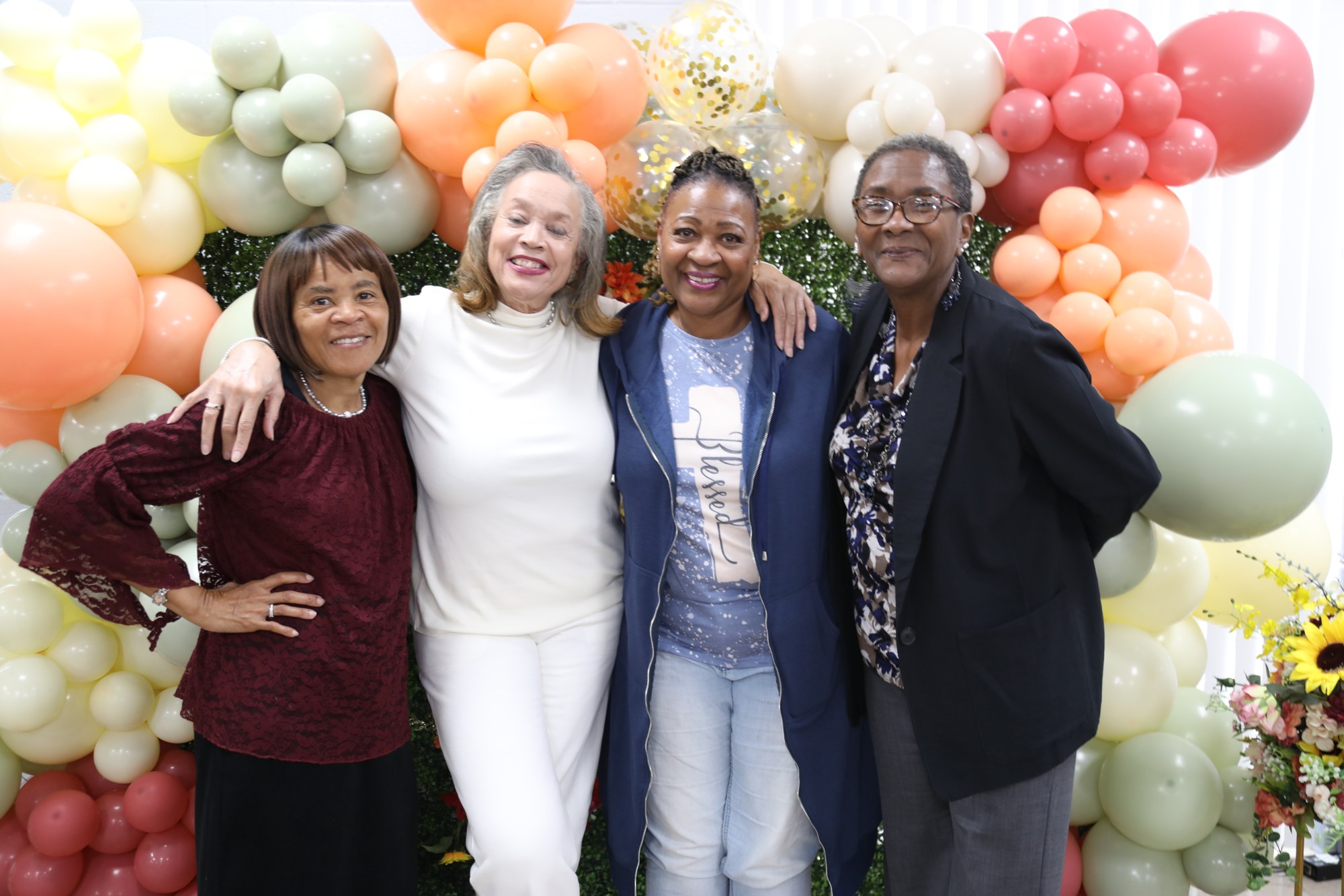 Four women smiling together at the 2025 Purposed Women Conference